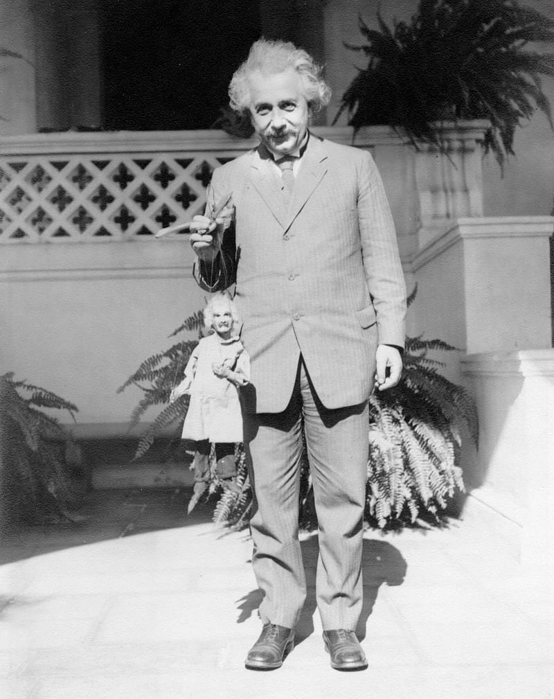 Albert Enstein poses with a puppet of his likeness